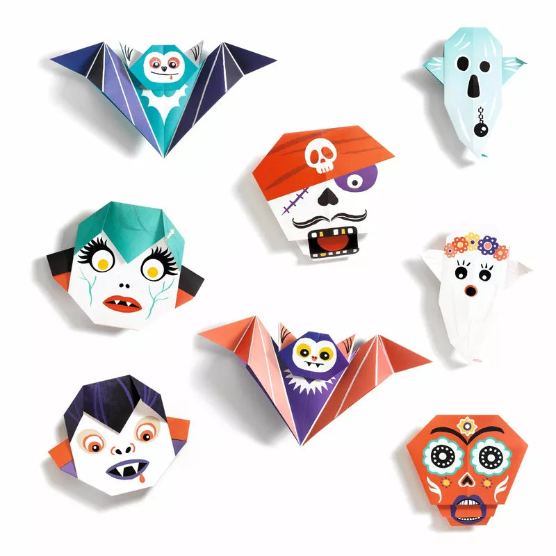 A group of fluorescent origami ghosts and bats on a white surface, created using the Djeco Origami Shivers.