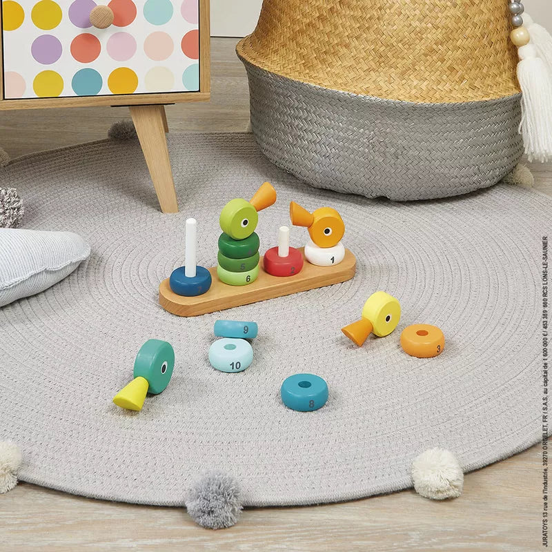 A child's play area with the Janod Zigolos Ducks Stacker on the floor.