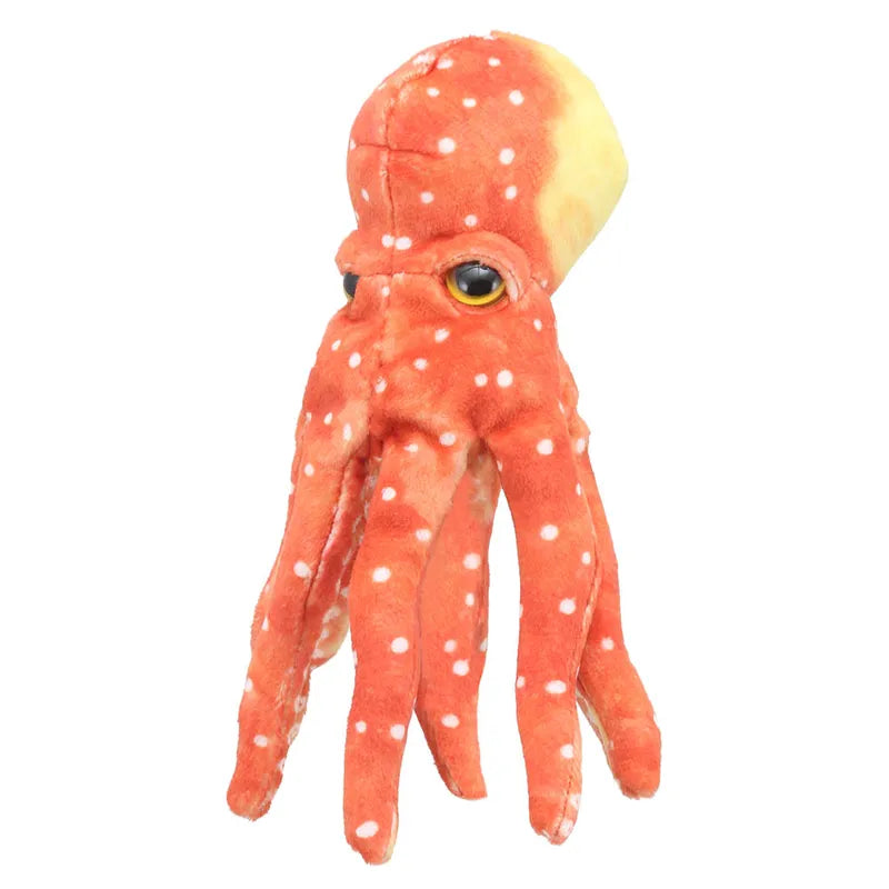 The Puppet Company Finger Puppet Octopus is a whimsical plush toy that combines the features of a squid with orange and white polka dots. It doubles as a finger puppet, features detailed eyes, soft tentacles, and is perfect for storytelling against a plain white background.