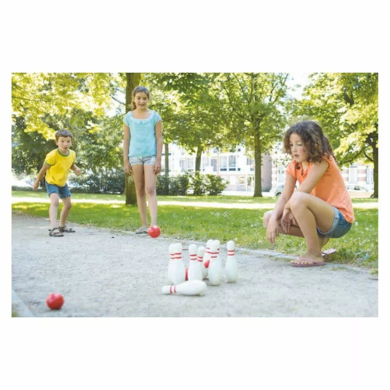a group of young children playing a game of bowling.
