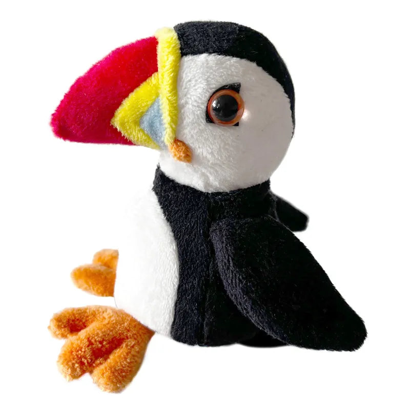 The Puppet Company Puffin Finger Puppet, perfect for imaginative play, features a black and white body with orange feet and a large multicolored beak. Its shiny eye adds charm, making it ideal for storytelling sessions against a plain white background.