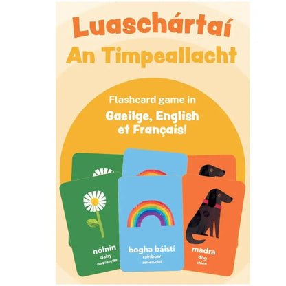 A poster for "Luaschártaí - An Timpeallacht," a trilingual flashcard game promoting language learning and environmental awareness, with Irish, English, and French words alongside images of a daisy, rainbow, and dog.
