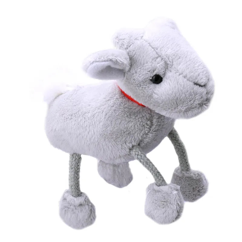 Introducing The Puppet Company Goat Finger Puppet: a plush toy goat with soft gray fur and a red collar, ideal for storytelling adventures. This whimsical soft toy features four rope-like legs and a stitched facial expression, capturing a playful, stylized charm reminiscent of a delightful finger puppet.