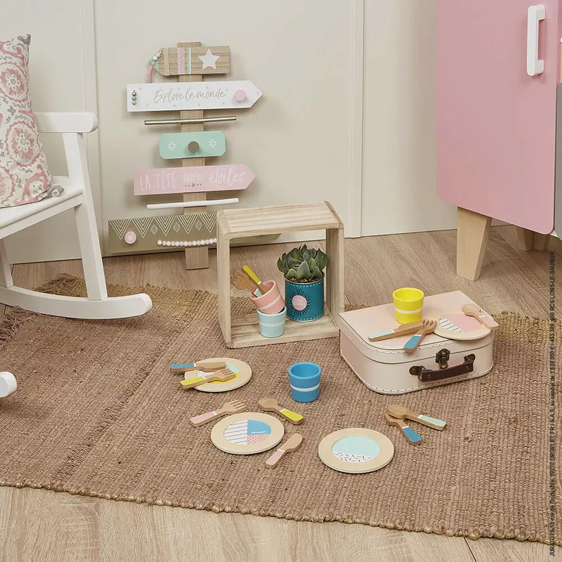 A Janod Dinnerware Set on a rug.