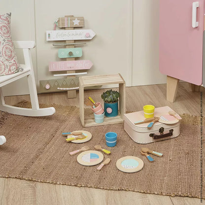 A Janod Dinnerware Set on a rug.