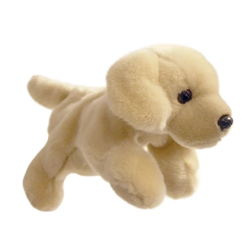 The Puppet Company Full-bodied Hand Puppet Labrador, a soft, light brown pupper with floppy ears and a cheerful expression, sits against a plain white background, inviting play and imagination.