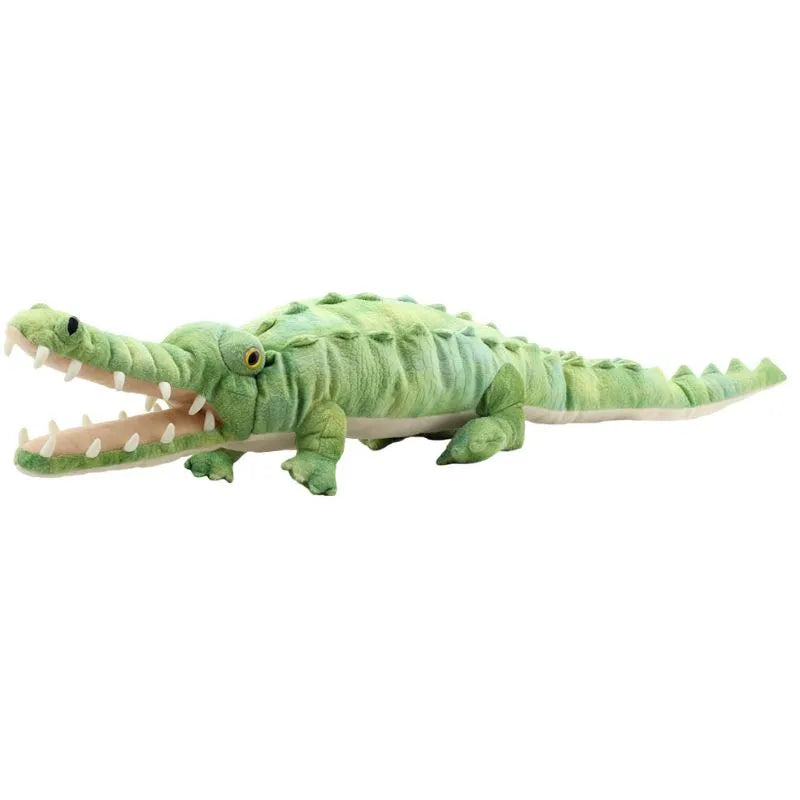 The Puppet Company Large Creature Crocodile is a plush hand puppet featuring textured green skin, an open mouth showing soft white teeth and a pink interior, with yellow eyes. Perfect for creative play as it rests on any flat surface.