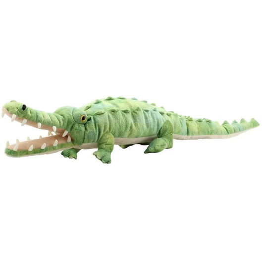 The Puppet Company Large Creature Crocodile is a plush hand puppet featuring textured green skin, an open mouth showing soft white teeth and a pink interior, with yellow eyes. Perfect for creative play as it rests on any flat surface.