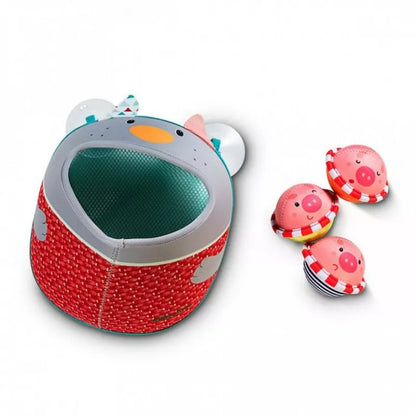 a Lilliputiens Nicolas Bath Toy shaped like a pig with a ball in it.