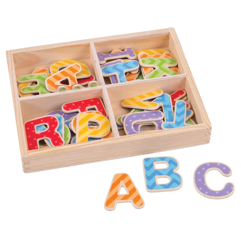 The Bigjigs Magnetic Letters (Uppercase) set includes colorful, patterned educational toy letters in a wooden box with four compartments. Letters like A, B, and C are displayed outside the box.