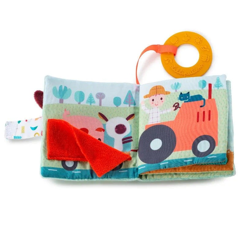 The Lilliputiens I'm Discovering Playbook Farm is a charming fabric baby book, perfect as a gift. It showcases a farm scene with a farmer on a red tractor and playful blue cat. A page hides surprises under a red flap, and an orange teething ring makes it ideal as baby's first toy.