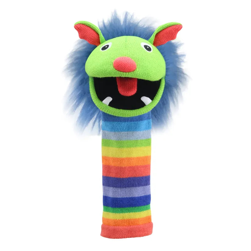 The Puppet Company Sockette Puppet Rainbow is a colorful hand puppet made from recycled materials, featuring a green face, blue furry mane, pink ears, red nose, rainbow-striped neck, white felt eyes, and a red tongue.