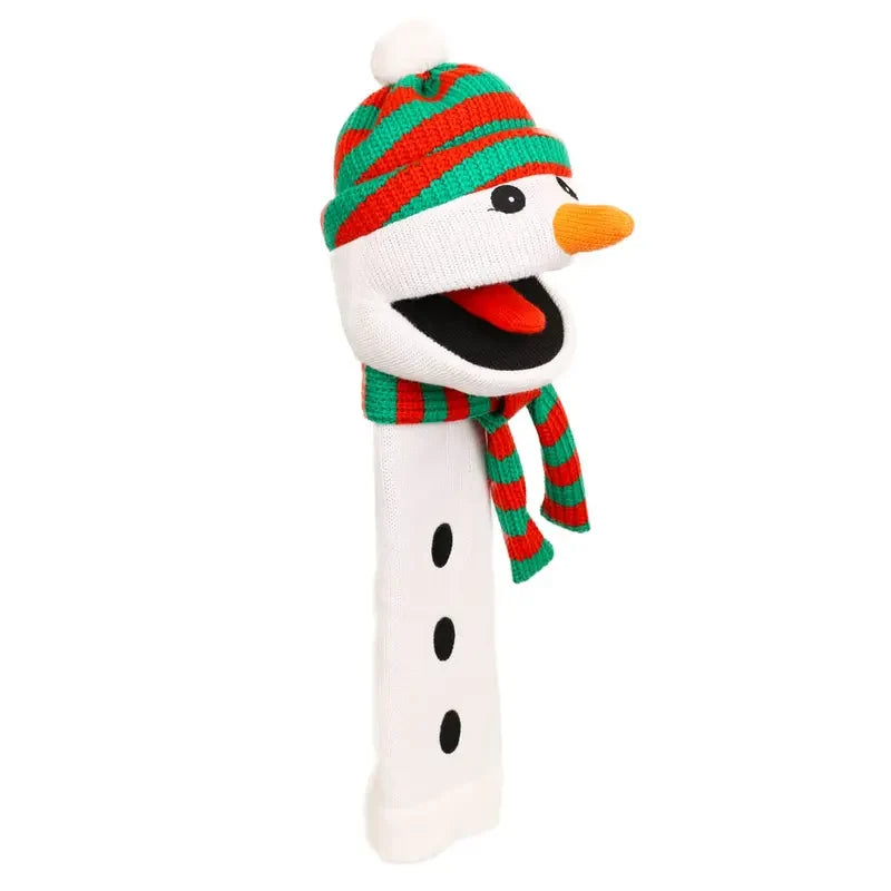 The Puppet Company Sockette Snowman is a hand puppet featuring a striped red and green hat and scarf, an orange carrot nose, black button details, and an open smiling mouth—crafted from recycled materials—making it a delightful Christmas gift.