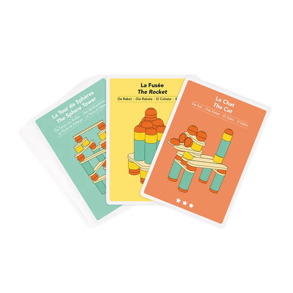 Three Stix Construction Creative Cards featuring illustrations and bilingual text in French and English, representing "the tower & the giraffe," "the rocket," and "the cat," to aid in language learning and object recognition.