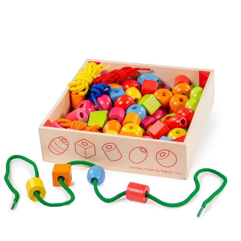 The Crate of Lacing Beads is a wooden box packed with multicolored beads and strings, functioning as an engaging educational toy. It includes cubes, cylinders, and spheres to aid fine-motor skill development. A green string with three beads is partially visible outside the box.