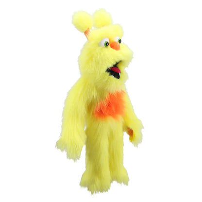 The Puppet Company Yellow Monster is a fuzzy yellow puppet with orange accents, large eyes, an open mouth, fluffy ears, and an expressive face. It stands upright with a playful and whimsical appearance.