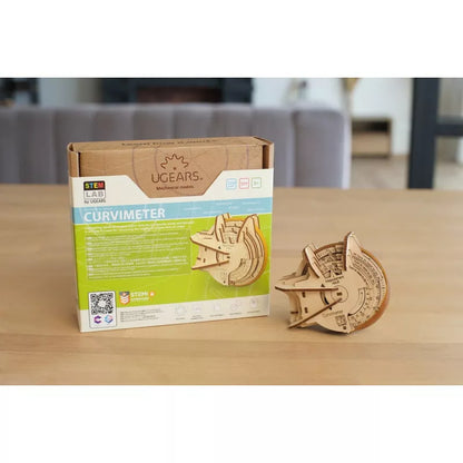 a wooden box with a Ugears Curvimeter STEM Lab Model toy on it.